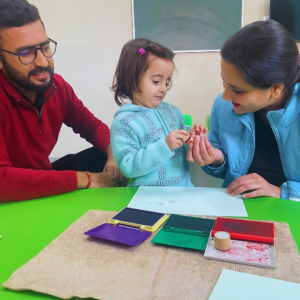 Parents and child engaged in CLAP Montessori activity at The Nurtuary Preschool, Sector 20 Panchkula