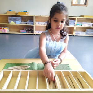 Kid engaging in Montessori Spindle Box activity at The Nurtuary Preschool, Sector 20 Panchkula - Best Playschool Near Me