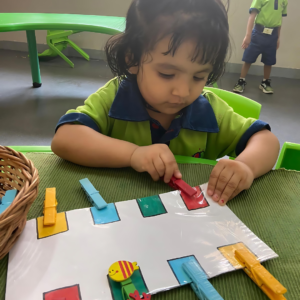 Kid engaging in fine motor skills activity at The Nurtuary Preschool, best playschool in Dhakoli