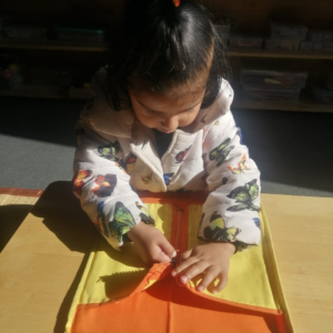 Kid enjoying zipping board Montessori activities at The Nurtuary Preschool, Sector 20 Panchkula
