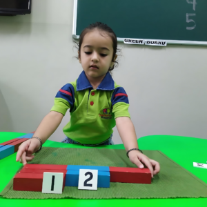 Kid learning numbers with Montessori number rod at The Nurtuary Preschool in Sector 20 Panchkula