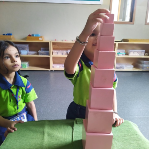 Kid building pink tower Montessori activity at The Nurtuary Preschool, Sector 20 Panchkula