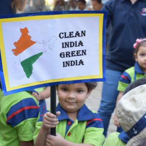 Kid holding placard during Earth Day rally at The Nurtuary Preschool - Preschool activities near Sector 21 Panchkula